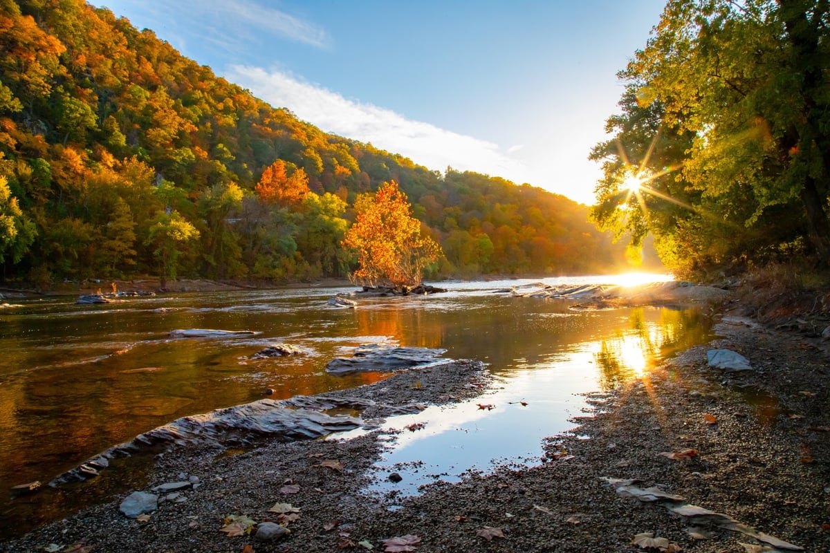 Peaceful river flowing through nature with sunset colors