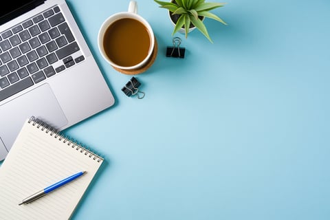 Professional desk setup with coffee and laptop for web design