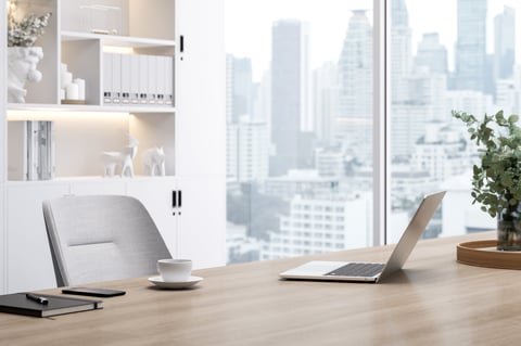 Modern office workspace with wooden desk and city view