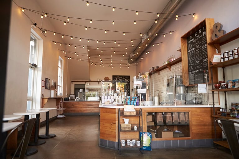 Cozy coffee shop interior with warm lighting and wooden furniture